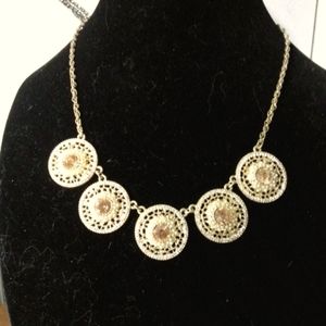 Gold necklace with round coin like pendants with AB Rhinestones.